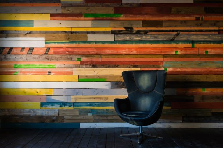 Modern egg chair on a colorful wooden wall