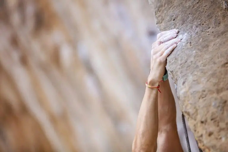Close up climber's hands on a cliff