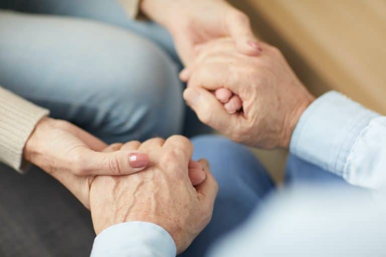 Caring Senior Couple Holding Hands