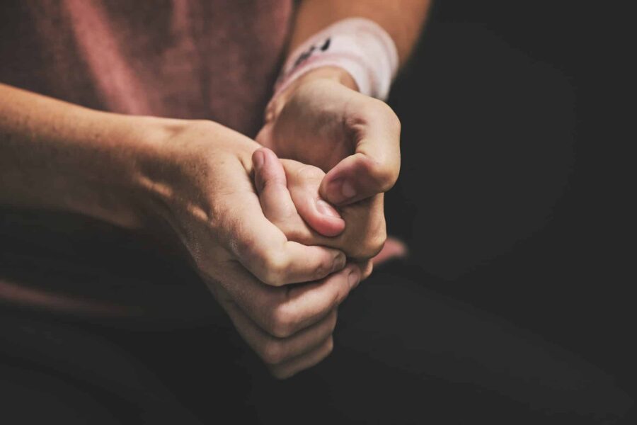 Woman with anxiety, hands scratch skin and stressed self harm picking mental health disorder. Nervo