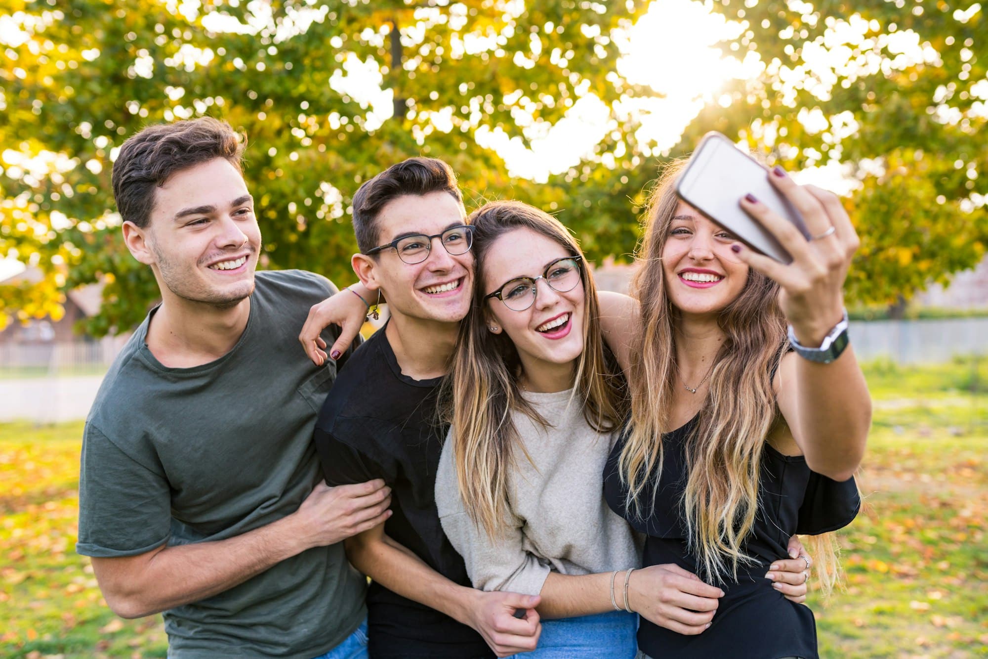 Teen friends at park taking a selfie and having fun